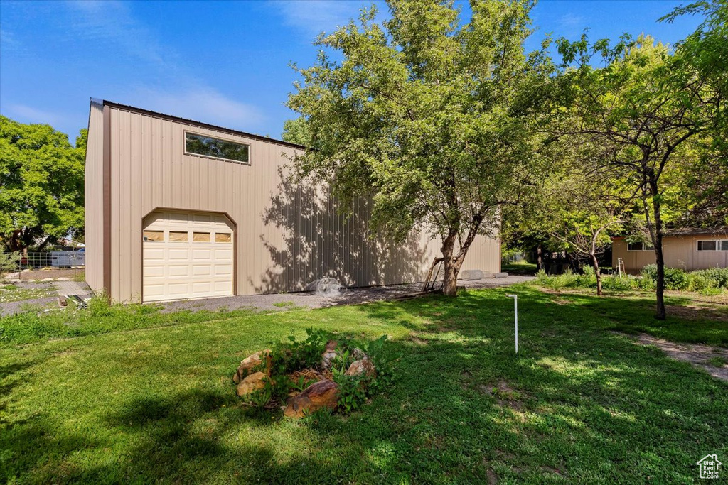 View of front facade featuring a garage and a front lawn