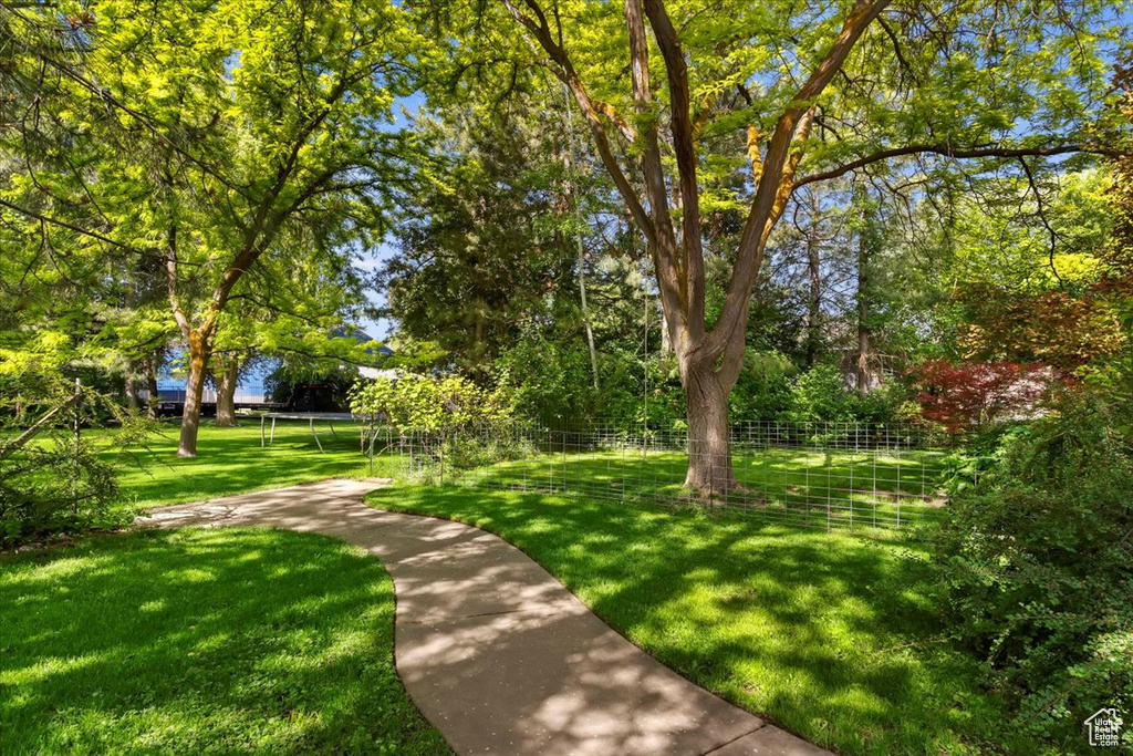 View of property\\\\\\\\\\\\\\\'s community featuring a lawn and a trampoline