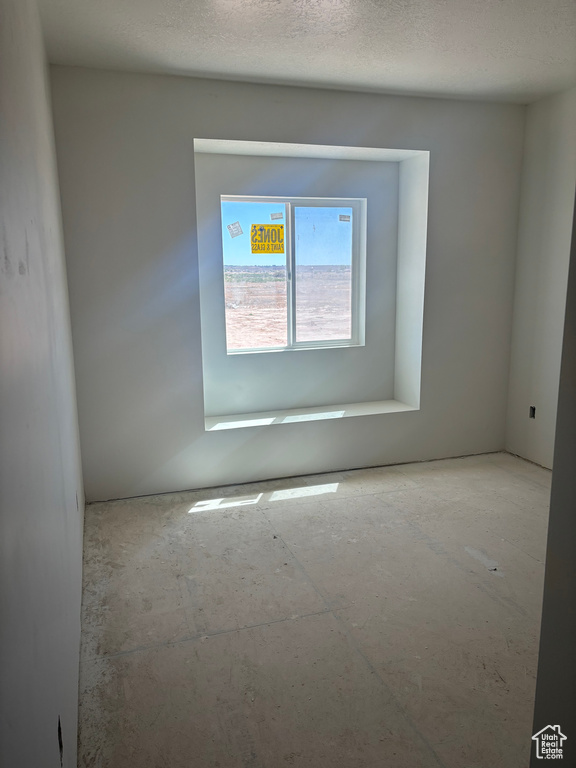 Spare room featuring a textured ceiling