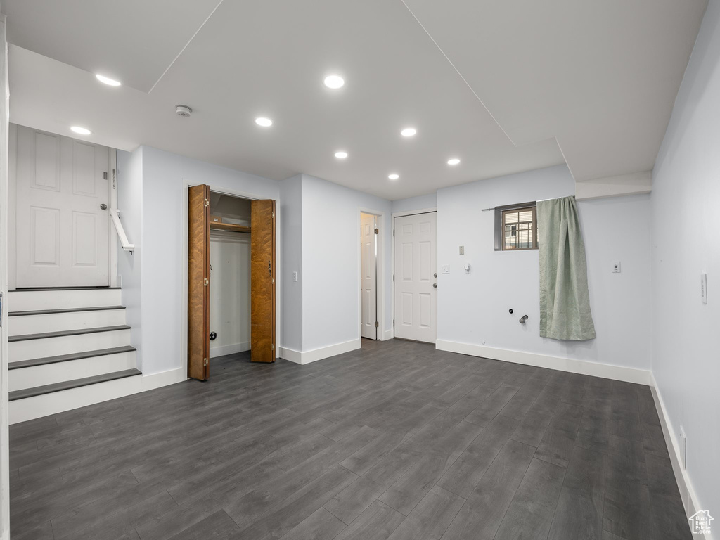 Basement with dark hardwood / wood-style flooring