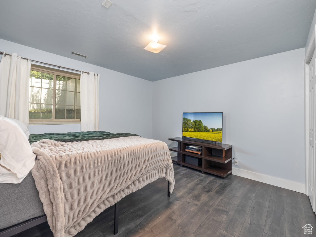 Bedroom featuring dark wood-type flooring