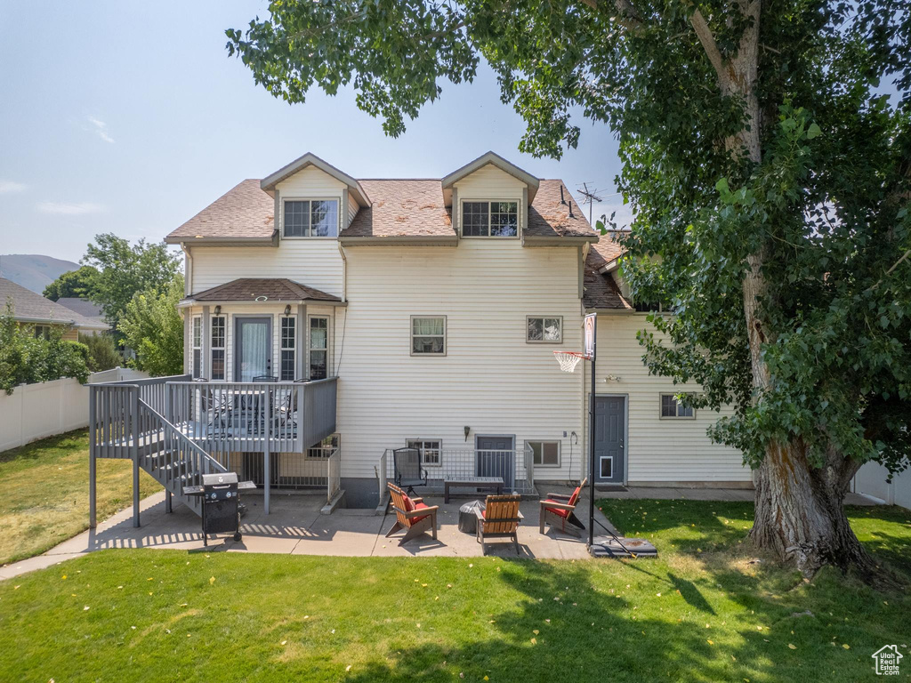 Rear view of house featuring a patio area and a lawn