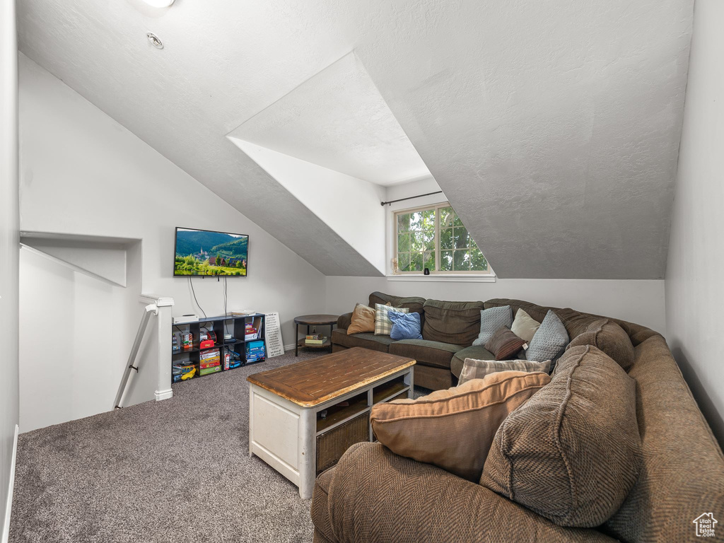 Carpeted living room with vaulted ceiling