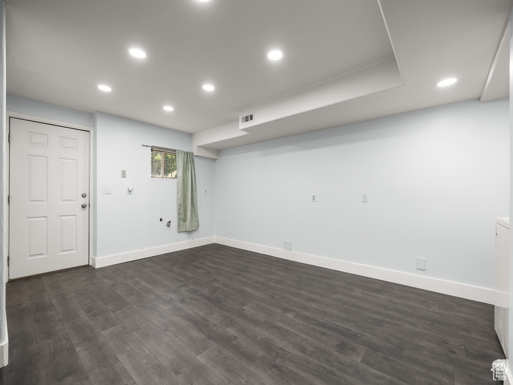 Basement with dark wood-type flooring