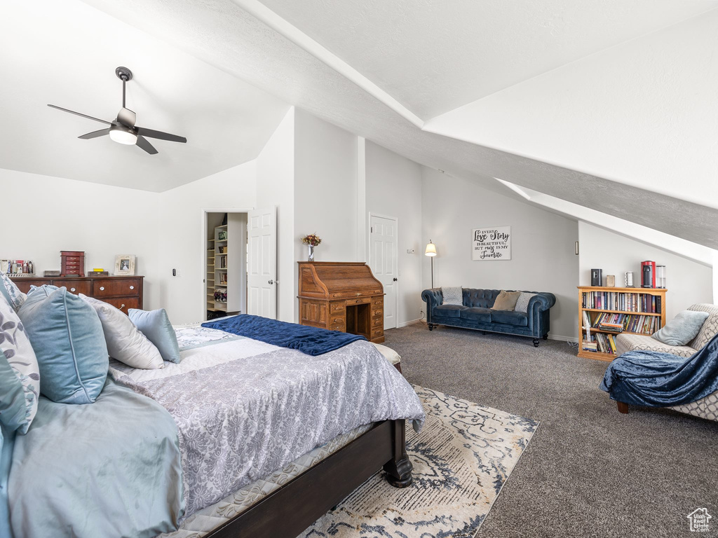 Carpeted bedroom with vaulted ceiling and ceiling fan