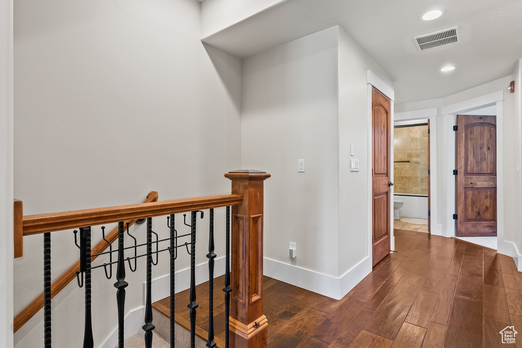 Corridor with dark hardwood / wood-style floors