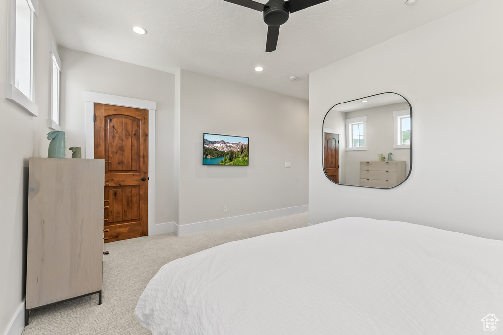 Carpeted bedroom with ceiling fan