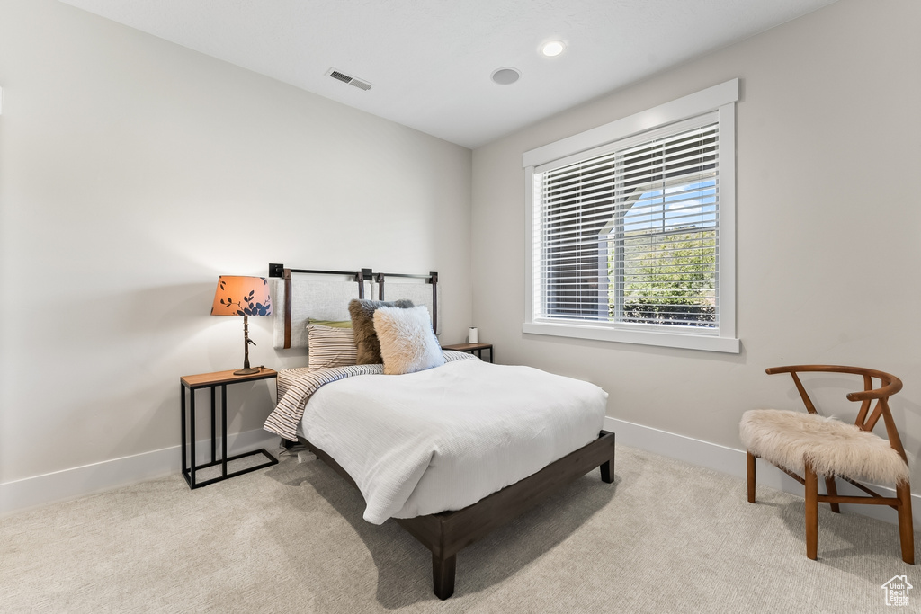 Bedroom featuring light colored carpet