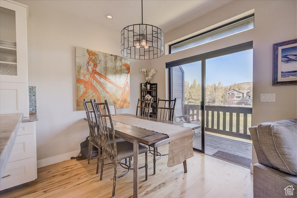 Dining area with an inviting chandelier and light wood-type flooring