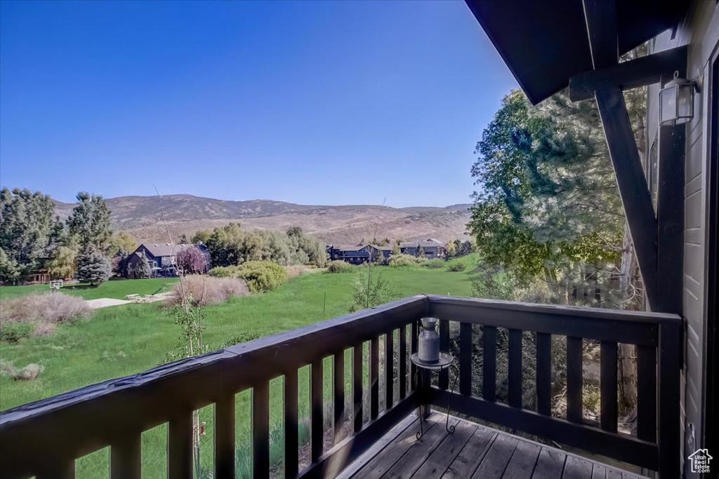 Wooden terrace with a mountain view and a lawn