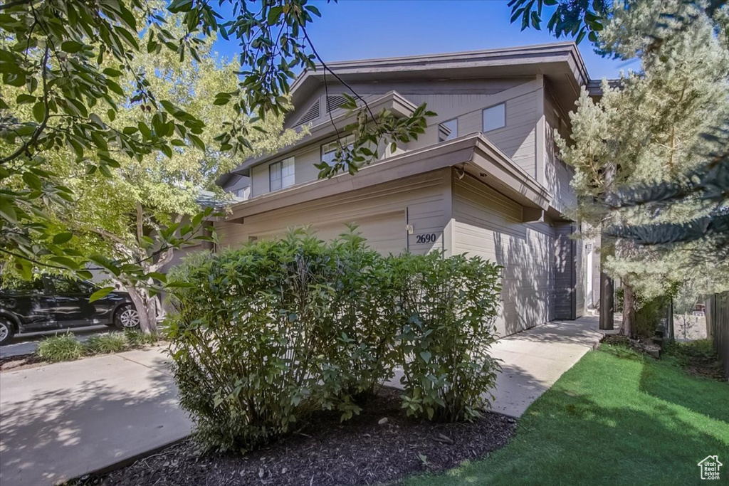 View of property exterior featuring a garage