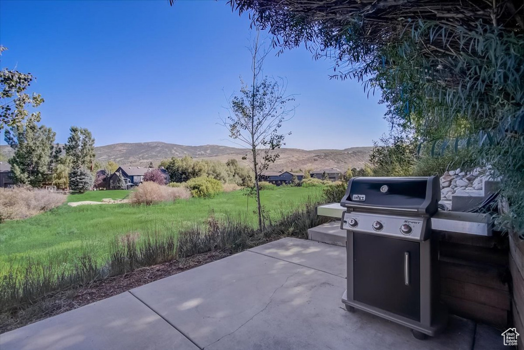 View of patio featuring a mountain view and area for grilling