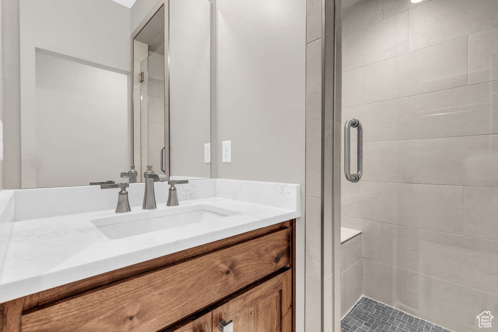 Bathroom featuring an enclosed shower and vanity