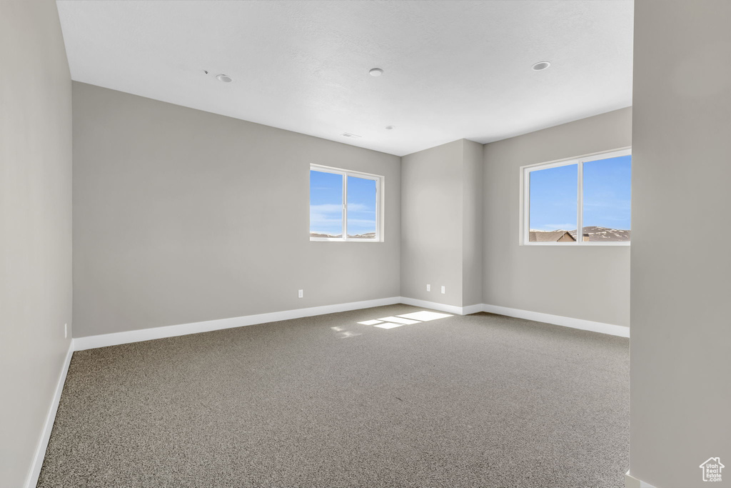 Carpeted empty room with plenty of natural light