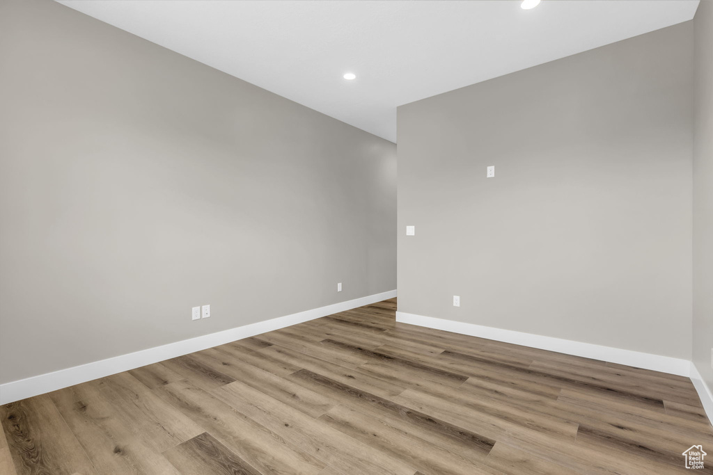 Empty room with hardwood / wood-style floors