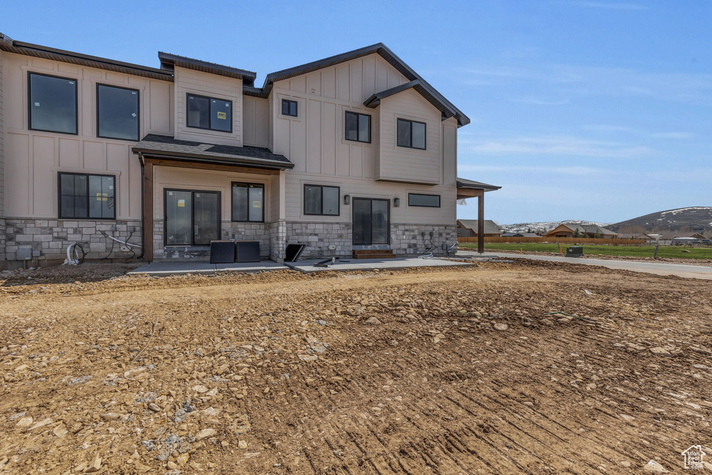 Back of property with a patio