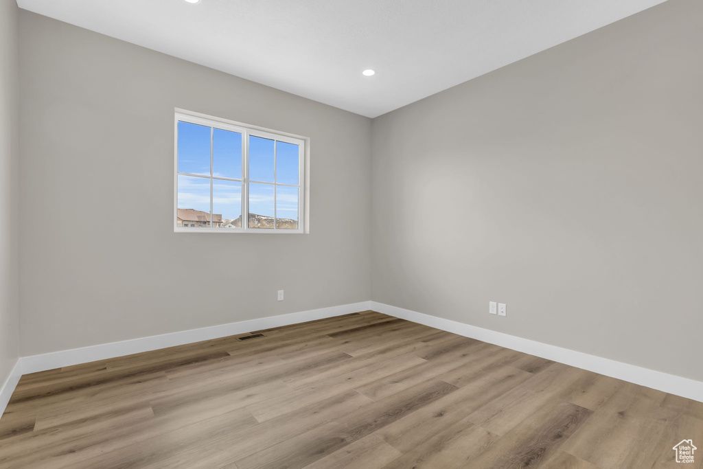 Unfurnished room with light hardwood / wood-style flooring