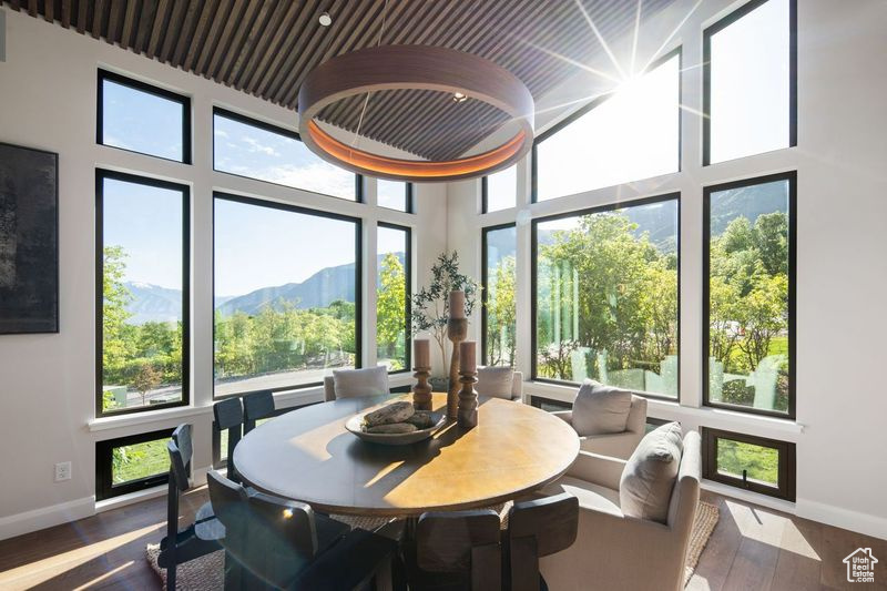 Sunroom featuring a healthy amount of sunlight and a mountain view