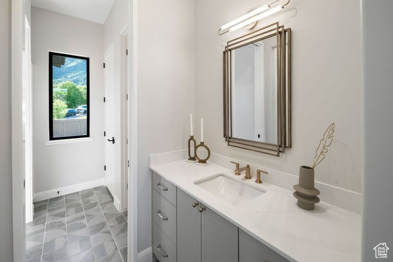 Bathroom featuring tile floors and vanity