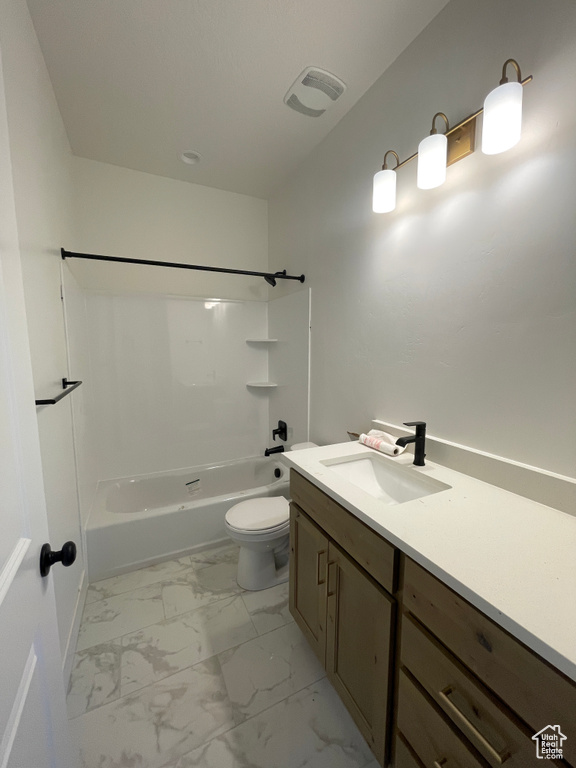 Full bathroom with vanity, toilet, and  shower combination