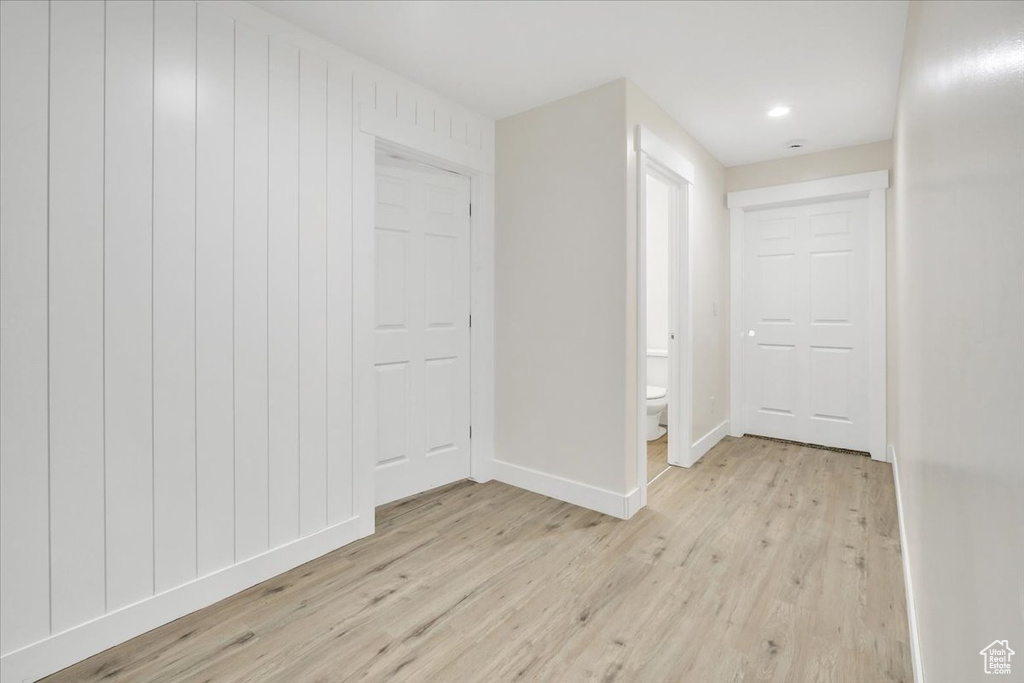 Hallway with light hardwood / wood-style flooring