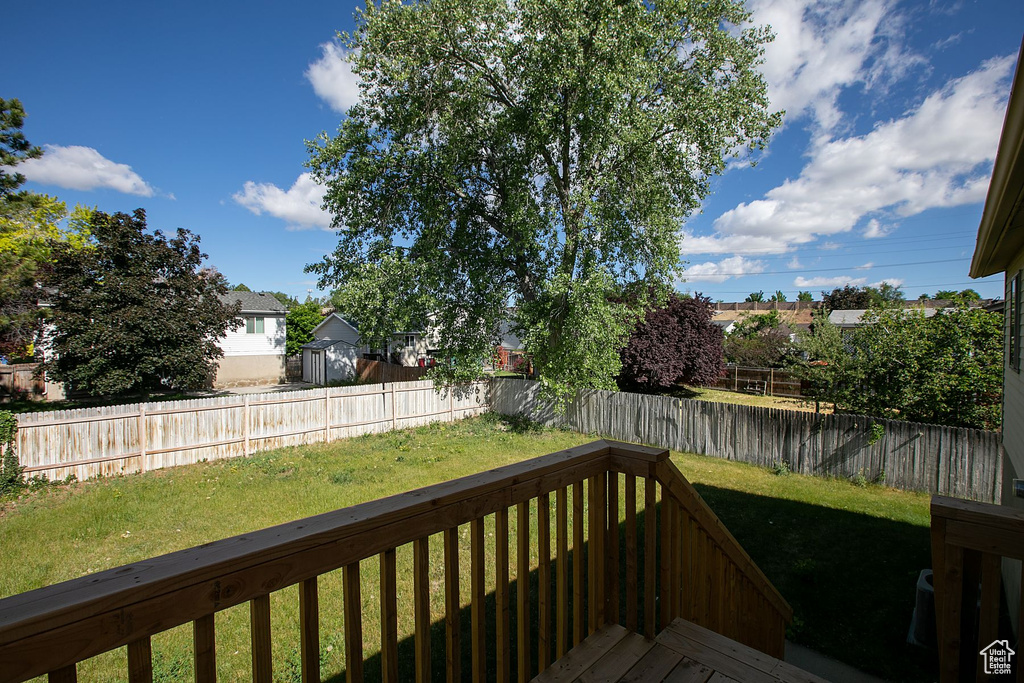 Wooden deck featuring a yard