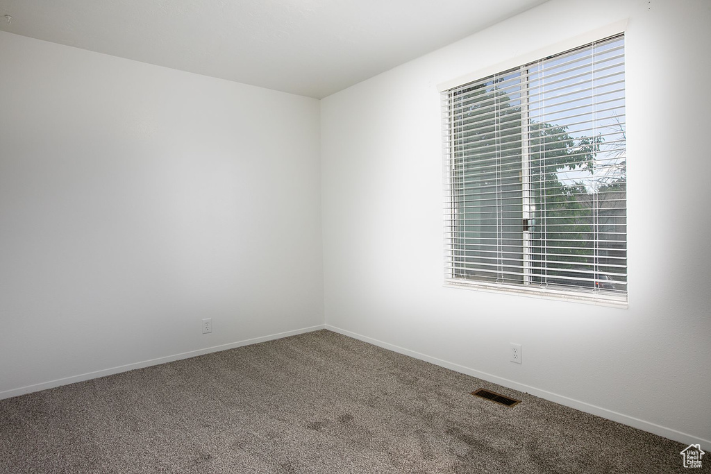 Spare room featuring carpet flooring