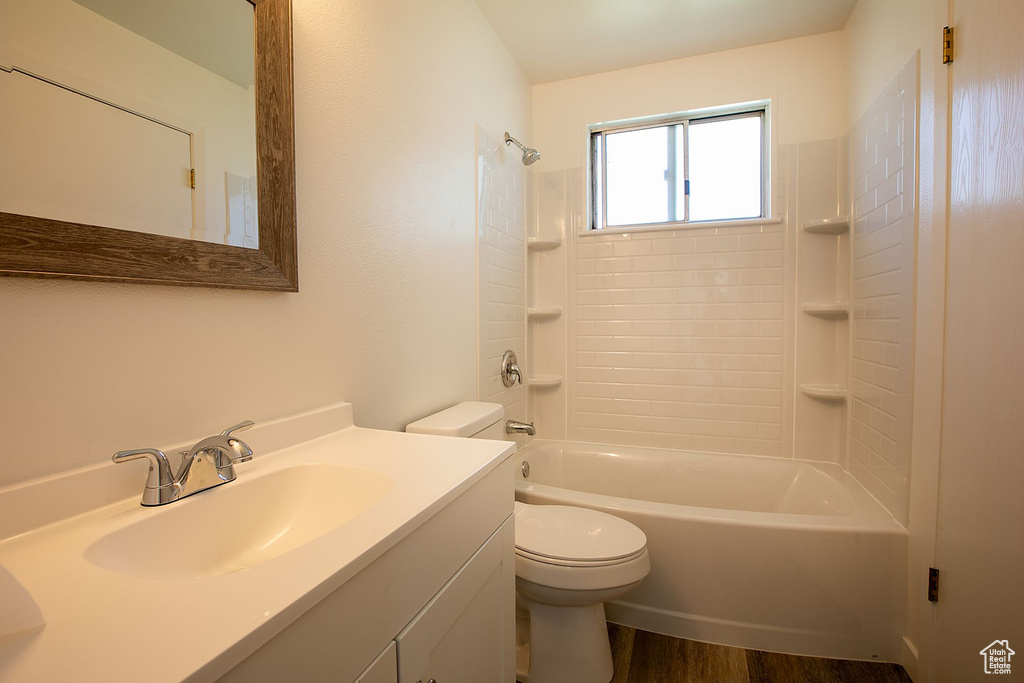 Full bathroom with shower / bath combination, vanity, toilet, and wood-type flooring