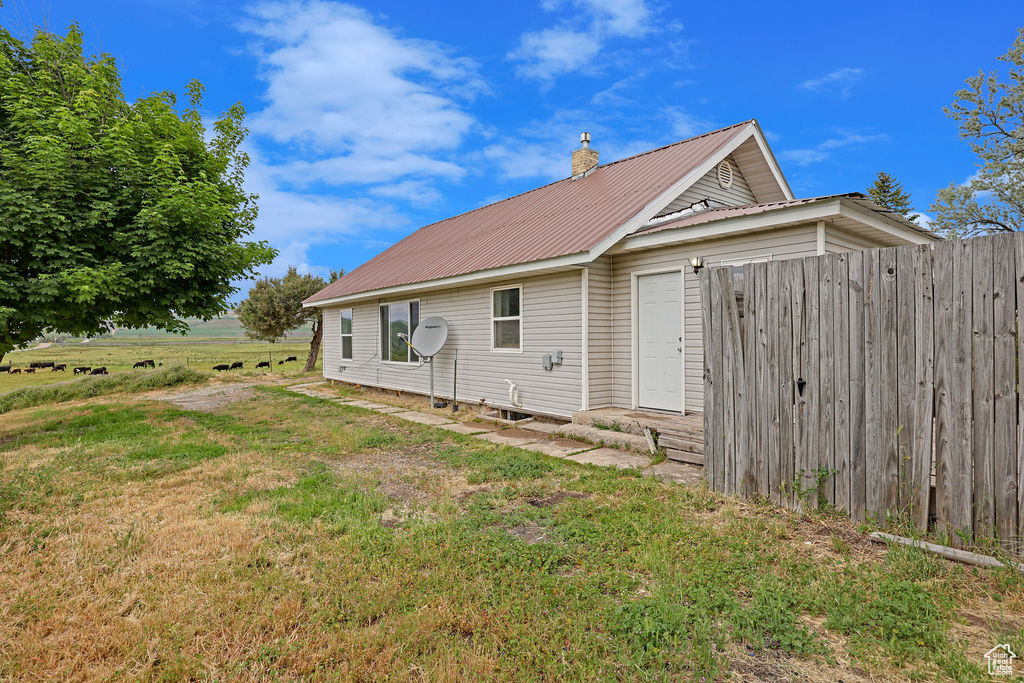 View of side of property featuring a yard