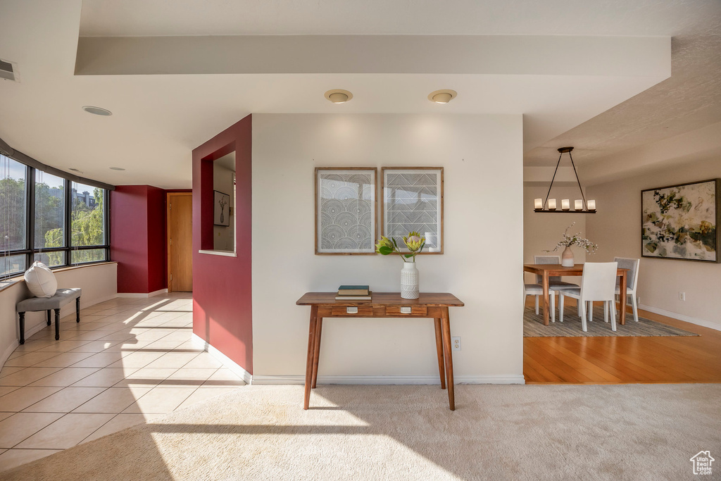 Corridor with hardwood / wood-style floors