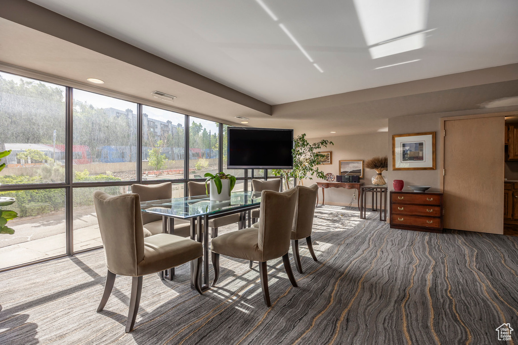 Dining room featuring dark colored carpet