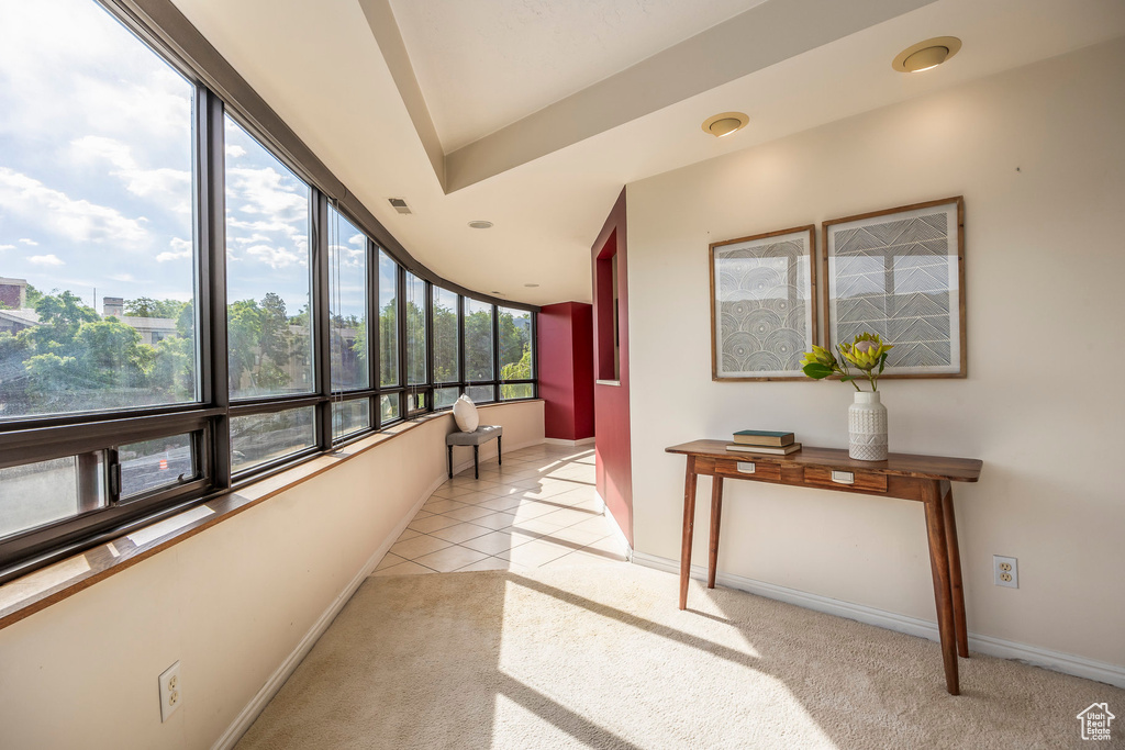 Interior space with plenty of natural light and light carpet