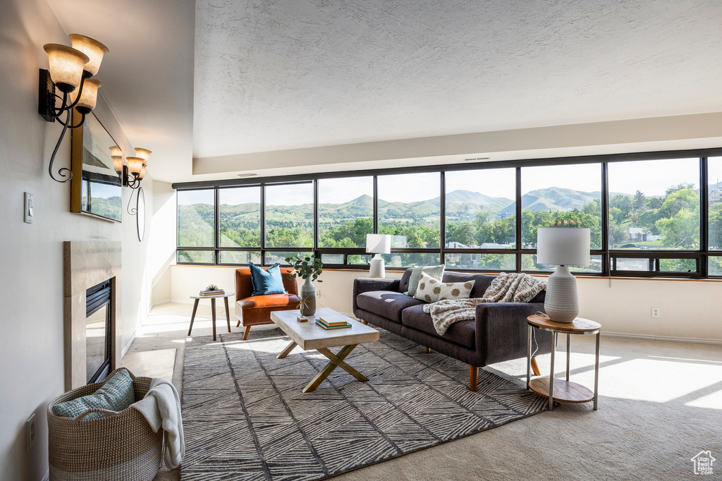 Living room featuring a mountain view, a high end fireplace, and carpet floors