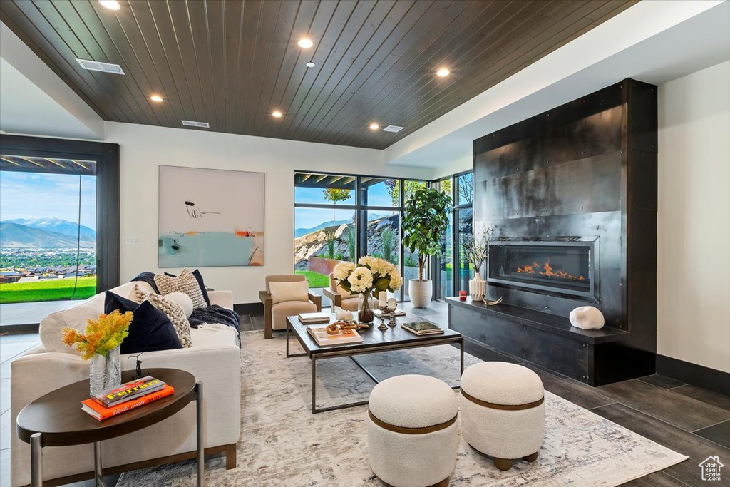 Living room featuring wooden ceiling and a mountain view