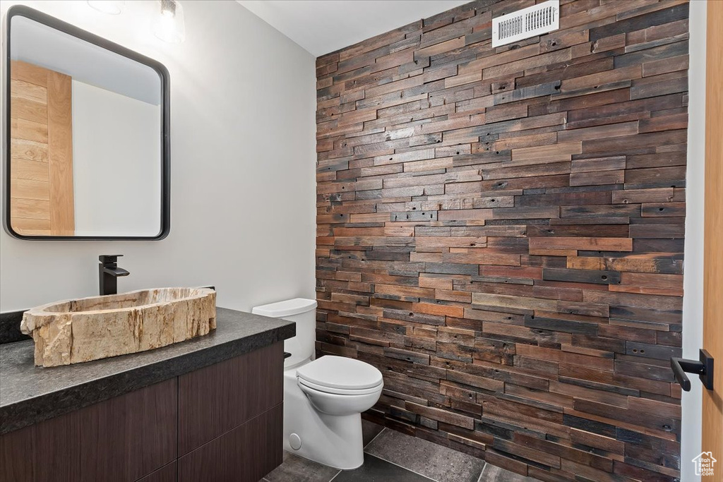 Bathroom with tile flooring, vanity, and toilet