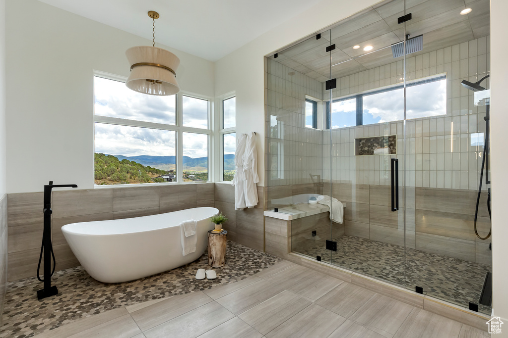 Bathroom with plus walk in shower, plenty of natural light, tile patterned flooring, and a mountain view