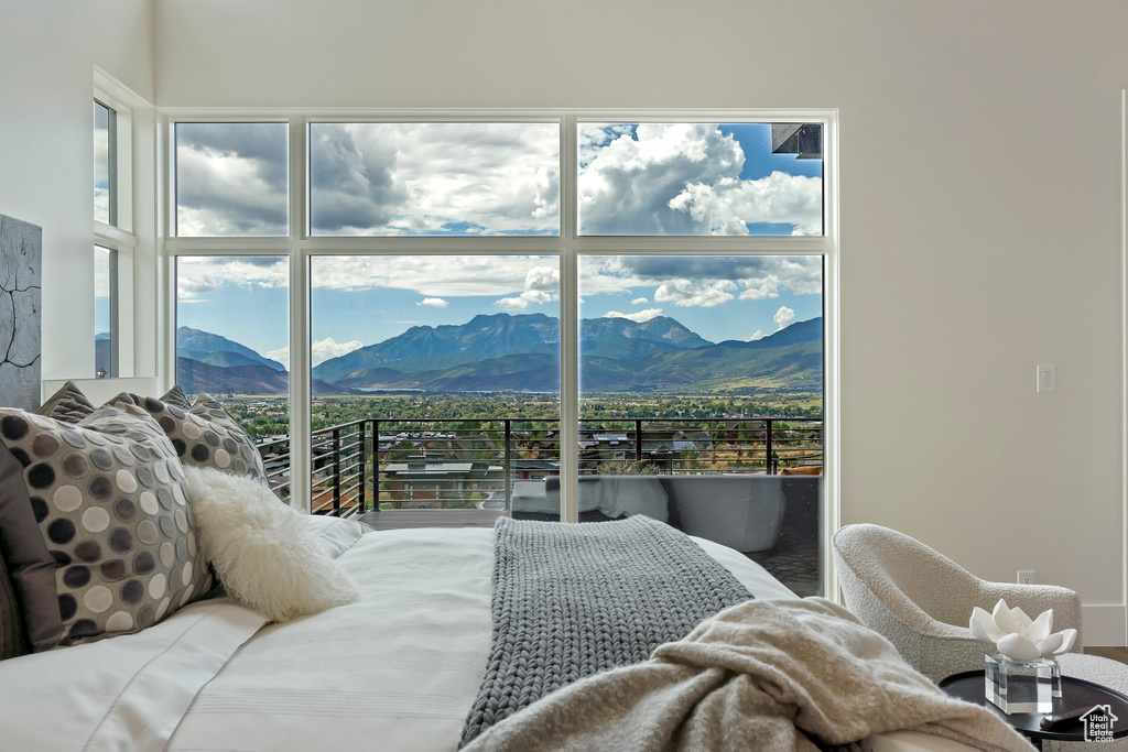 Bedroom featuring multiple windows and a mountain view