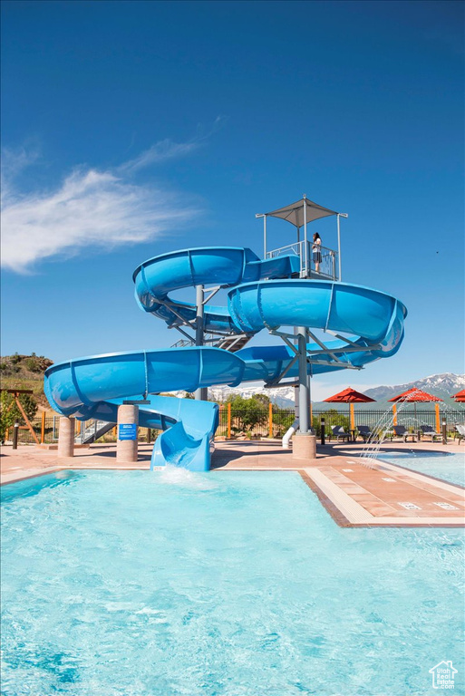 View of swimming pool with a water slide