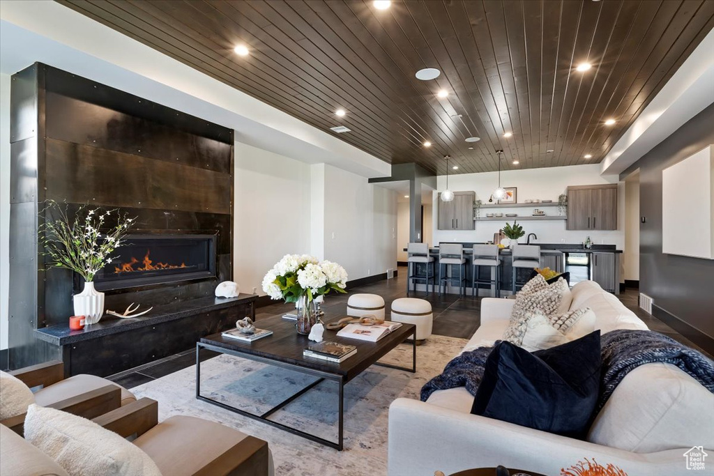 Tiled living room with a premium fireplace and wood ceiling