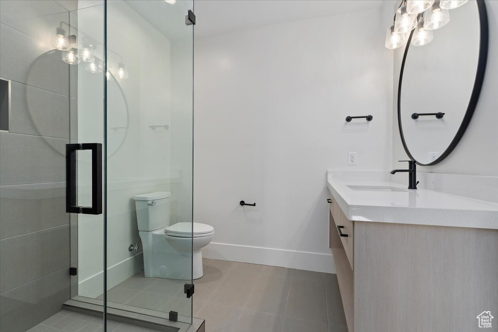 Bathroom with tile floors, oversized vanity, and toilet