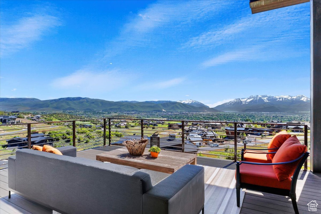 Wooden terrace featuring a mountain view