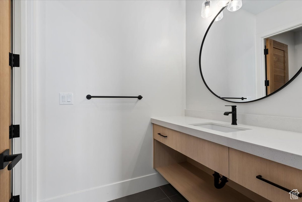 Bathroom featuring tile floors and vanity