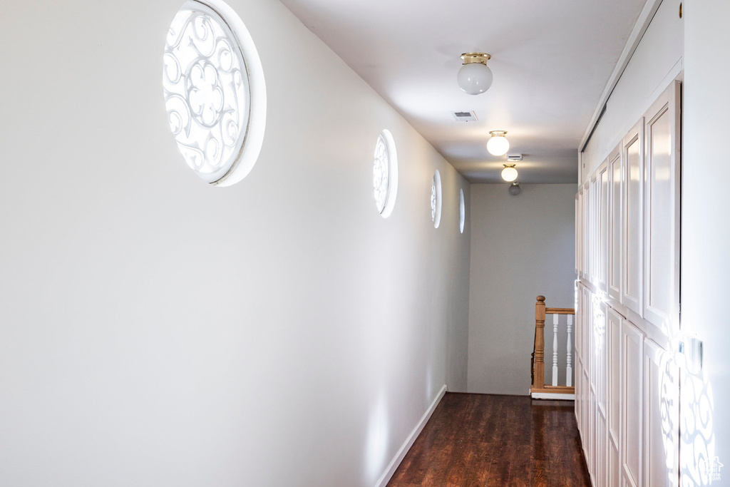 Hall featuring dark wood-type flooring