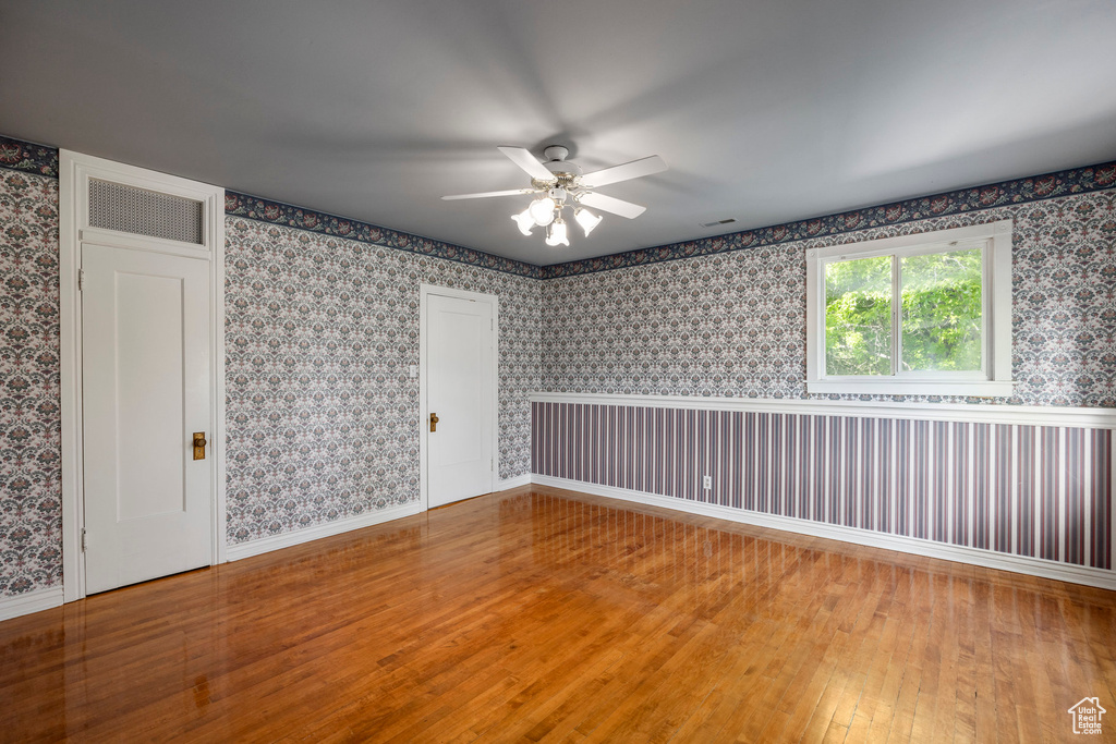 Unfurnished room featuring ceiling fan and wood-type flooring