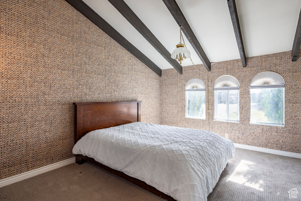 Bedroom featuring lofted ceiling with beams and carpet flooring