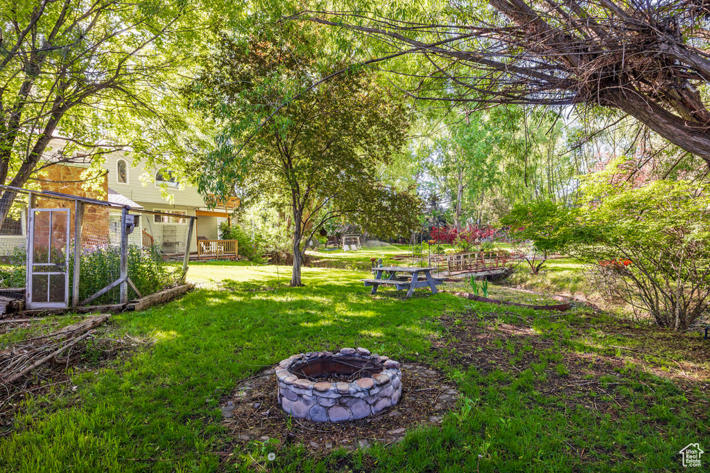 View of yard featuring an outdoor fire pit and a deck