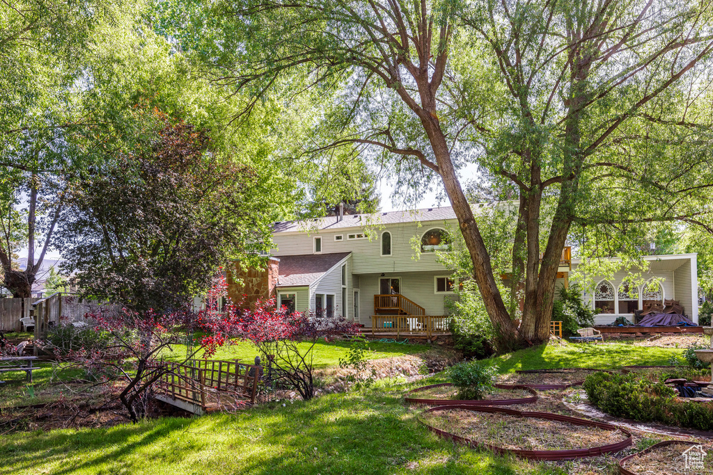 Exterior space featuring a deck and a front yard