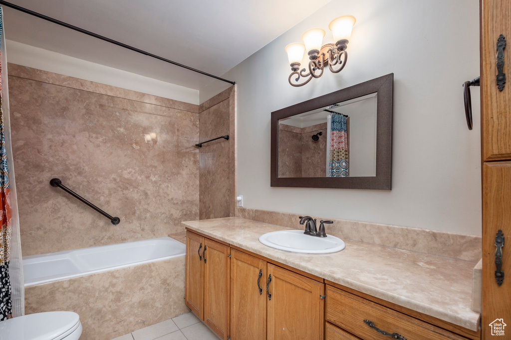 Full bathroom with tile flooring, shower / bath combination with curtain, vanity, and toilet