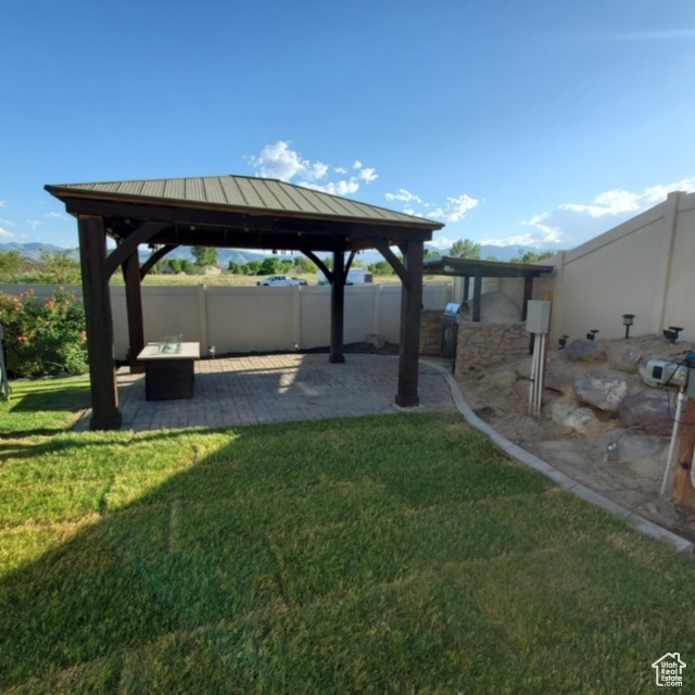 View of yard with a gazebo and a patio