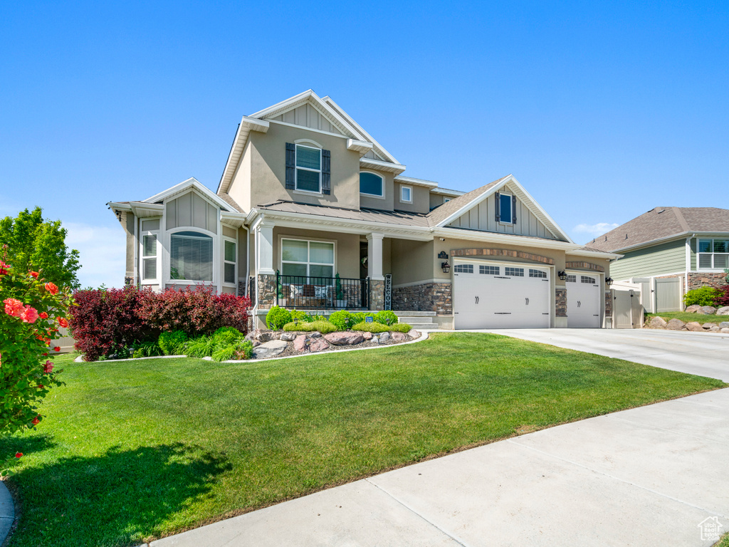 Craftsman-style house with a front yard and covered porch